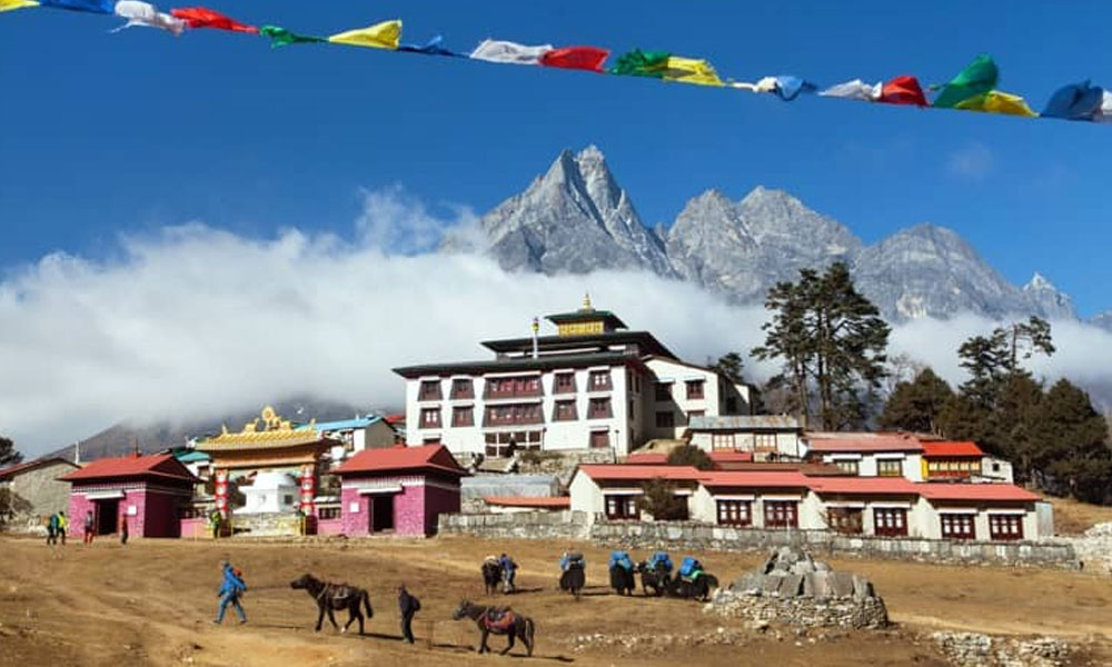 Tengboche Monastery with prayer flags and Himalayan mountains in the background