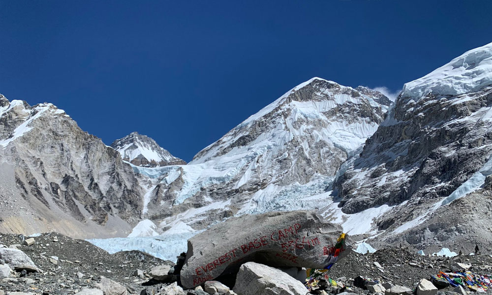 Mount Everest rising above glaciers and rocky terrain at Everest Base Camp.